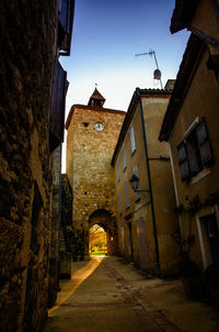 Narrow street amidst old buildings in city