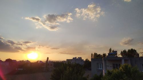 Silhouette buildings against sky during sunset