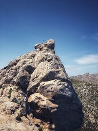 Low angle view of rock formations against sky