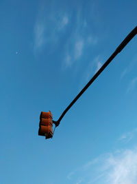 Low angle view of street light against blue sky