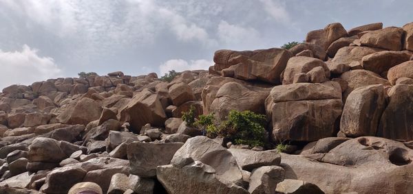 Low angle view of rocks against sky