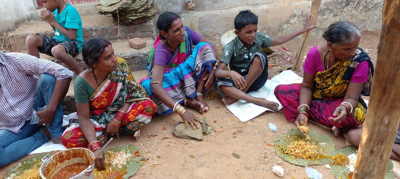 group of people, adult, men, women, sitting, lifestyles, temple, poverty, high angle view, traditional clothing, sari, togetherness, tradition, young adult, food, food and drink, day, religion, friendship, outdoors, tribe, nature, leisure activity, multi colored, village, architecture, female, group, crowd, indigenous culture, casual clothing