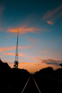 Silhouette of road against sky during sunset