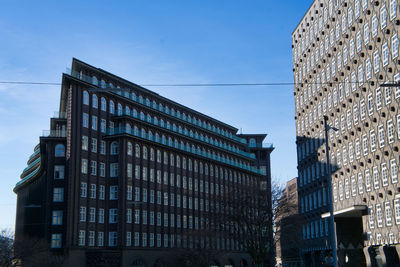 Low angle view of modern buildings against sky in city