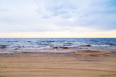 Scenic view of sea against cloudy sky