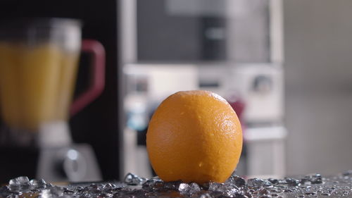 Close-up of orange juice on table