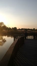 Scenic view of lake against clear sky at sunset