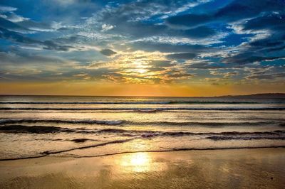 View of calm beach at sunset