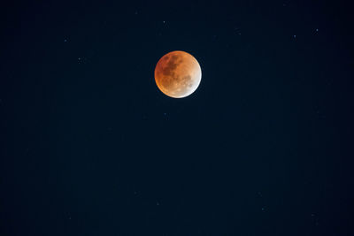 Low angle view of moon against clear sky at night