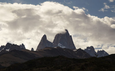 Scenic view of mountains against cloudy sky