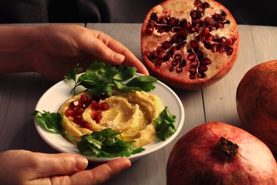 Cropped image of person holding fruit salad