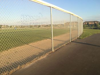 Scenic view of field seen through chainlink fence