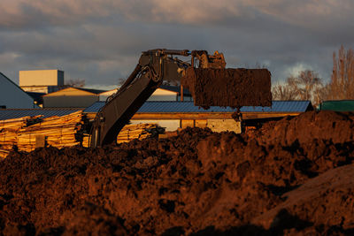 Construction crane working at sunset