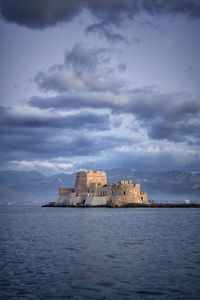 Sea fortress bourtzi against cloudy sky