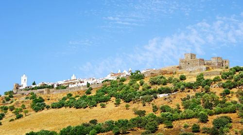 Low angle view of castle on mountain at monsaraz against sky