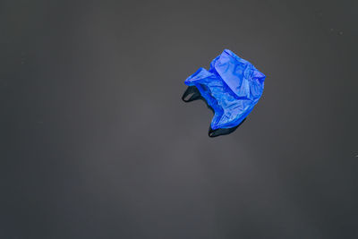High angle view of blue plastic bag on floor