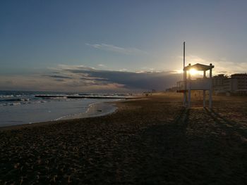 Scenic view of beach against sky during sunset