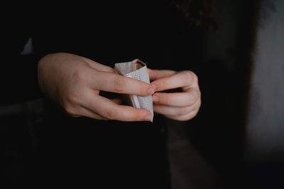 Holds a filter bag in his hands, with ground caffeine, alternative brewing of a coffee drink, funnel