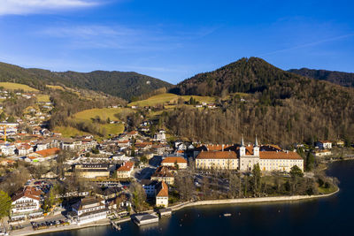 High angle view of townscape by mountain against sky