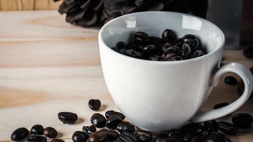 Close-up of coffee beans in glass on table