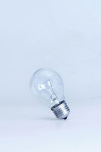 Close-up of light bulb against white background