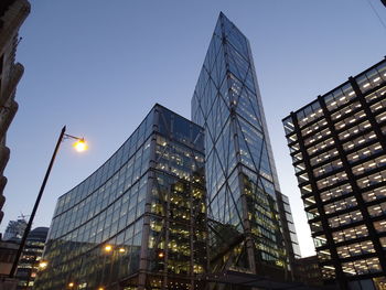 Low angle view of illuminated buildings against sky at dusk