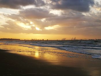 Scenic view of beach against sky during sunset