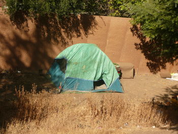 Rear view of tent on field against trees