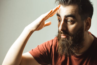 Close-up of shocked man against gray background