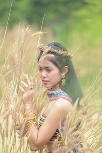 Portrait of young woman in field