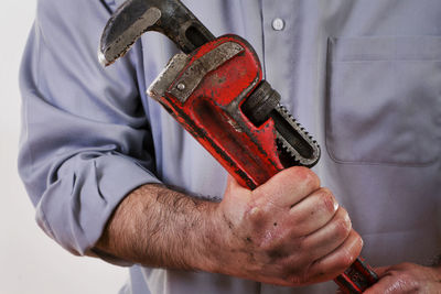 Midsection of man holding equipment