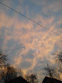 Low angle view of bare trees against sky