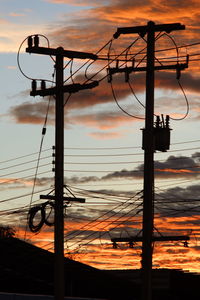 Silhouette street light against sky during sunset