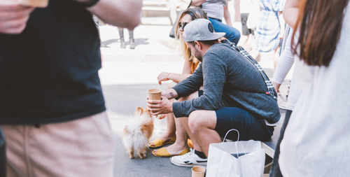 People with dog on street in city