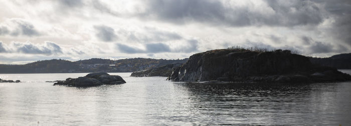 Panoramic view of rocks in sea against sky