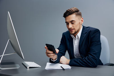 Young man using laptop while sitting on sofa at home