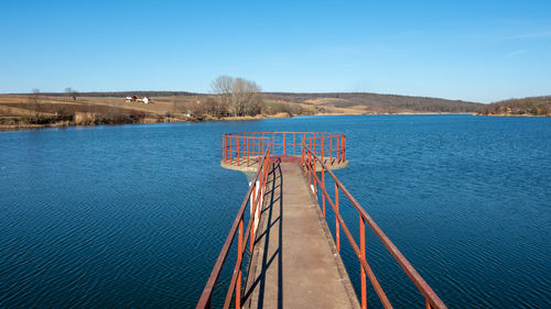 Scenic view of lake against clear blue sky