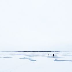 High angle view of people on frozen lake