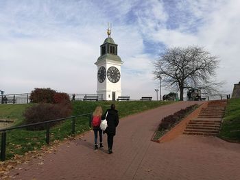 People walking on walkway against sky