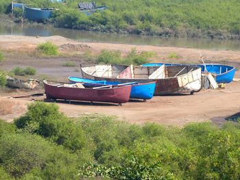 Boat moored on shore by lake