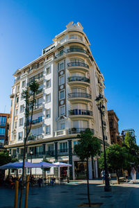 Low angle view of buildings against clear blue sky