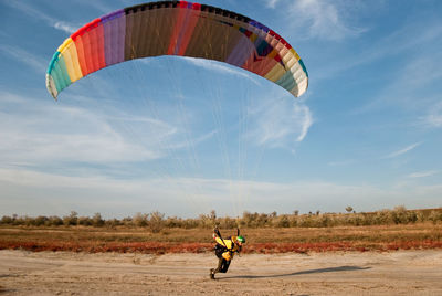 Man paragliding on landscape