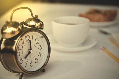 Close-up of clock on table at home