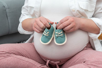 Midsection of woman holding heart shape