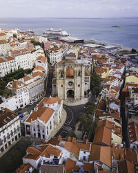 High angle view of townscape by sea against sky