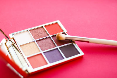 Close-up of beauty products against yellow background