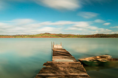 Pier over lake against sky