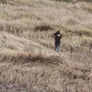 Full length of woman standing on grassy field