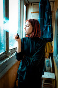 Depressed woman smoking indoor