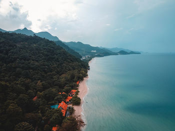 High angle view of sea and mountains against sky